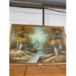Large oil painting depicting river and forest scene signed Jin P in gilt framing .