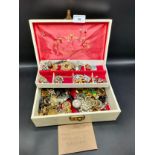 Box of vintage jewellery and vintage brooches .
