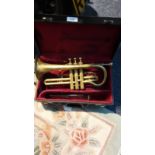 Brass trumpet in original fitted case with mouthpiece with folding music sheet stand .