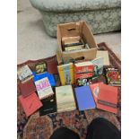 Box of books to including Ian Fleming and other book titles .