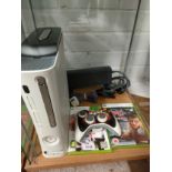 Xbox 360 with controllers and games .