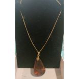 14 CT 585 gold chain with large amber stone pendant . 1 gram.