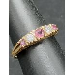 9ct gold ring set with ruby and clear stones .
