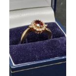 9ct gold garnet and clear stone ring .