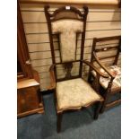 Large antique arm chair with unusual design set with silk upholstery.