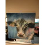 Large oil painting of a cow signed by J Hutchinson.