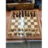 Vintage Chess board with wooden pieces .