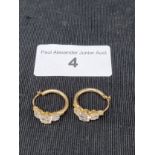Pair of heavy 9ct gold earrings set in ring design with stones .