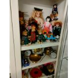 3 shelfs of miscellaneous includes porcelain dolls .