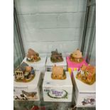 Shelf of Lilliput lane s with boxes .