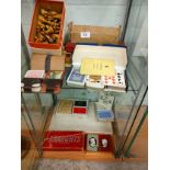 2 shelf of playing cards , chess set with boards etc .