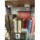 Shelf of antique books includes wininthe pooh by AA Milne .