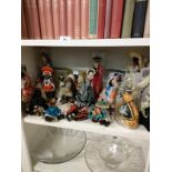 Shelf of vintage dolls of the world etc .