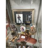 Shelf of John Wayne collectables items .