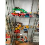 3 Shelf of playworn dinky vehicles , farm animals etc .