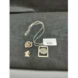 Silver necklace with dog pendant etc .
