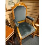 Antique light oak throne chair with light blue velvet upholstery.