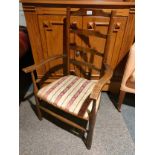 Early antique arm chair with ladder design .