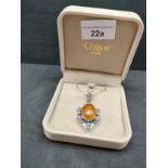 Good quality silver pendant with Baltic set amber stone on a silver chain .