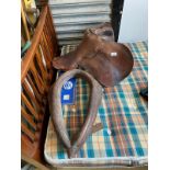 Leather horse saddle together with horse item .