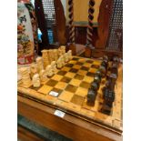 Vintage chess board with wooden complete chess set in monk themed .