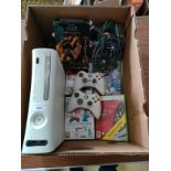 Xbox 360 console with controllers and games .