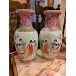 Large Pair of Oriental Vases depicting gheisha woman scene signed to base . 18 inches in height .