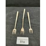 3 silver hall marked bladed pickle forks .