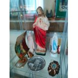 Shelf of religious figures etc .
