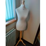 As new Taylors dress manikin on wooden supported stand .