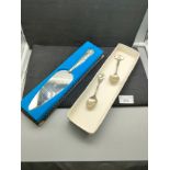Silver hall marked handle cake server together with 2 silver hall marked enamel spoons .