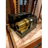 Antique magic lantern with metal fitted casing .