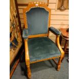 19th century light oak arm chair with light blue upholstery.