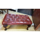 Oxblood leather chesterfield stool with queen Anne legs .
