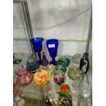 Shelf of art glass wares includes blue Bristol glasses etc.