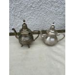 2 middle Eastern white metal tea pots .