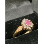9ct gold diamond and ruby setting ring .