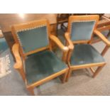 Pair of oak light wood arm chairs with blue upholstery.