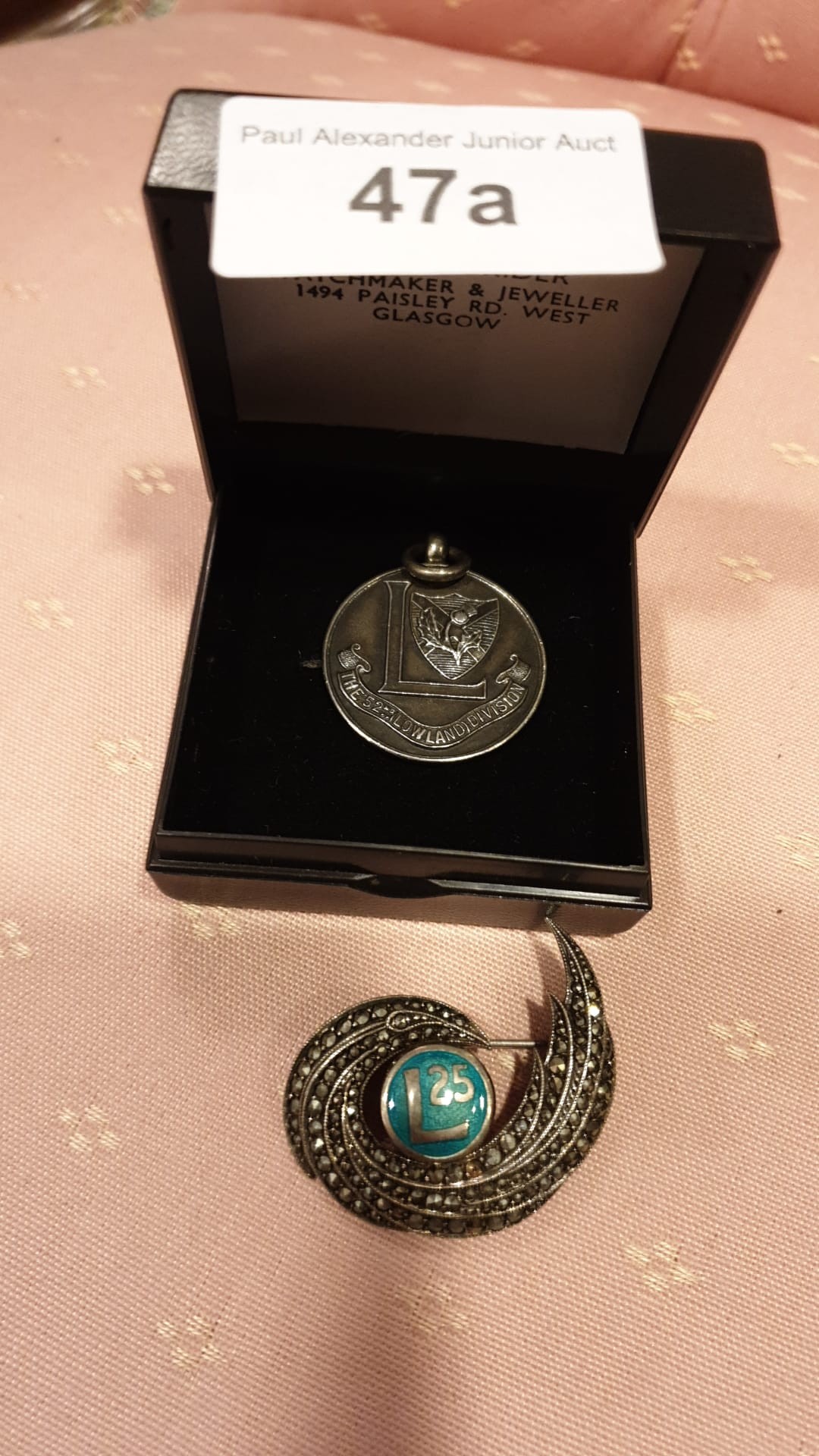 Silver medal and silver brooch .