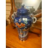 Large porcelain temple jar in blue with floral decoration . 12 inches in height.