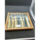 Collection of collector cut throat knifes in fitted display .