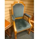 Early Oak arm chair with blue upholstery.