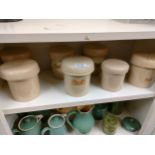 Shelf of antique ceramic storage jars .