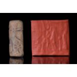CYLINDER SEAL OF FAIENCE WITH TRACES OF TURQUOISE GLAZE