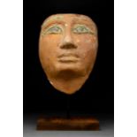 AN EGYPTIAN GESSO-PAINTED WOOD MUMMY MASK