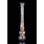 A ROMAN GLASS CANDLESTICK UNGUENTARIUM