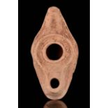 A ROMAN POTTERY OIL LAMP