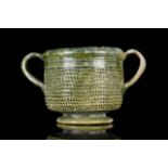 AN EARLY ROMAN LEAD-GLAZED POTTERY SKYPHOS