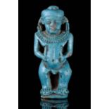AN EGYPTIAN FAIENCE TURQUOISE GLAZED COMPOSITION PATAIKOS AMULET