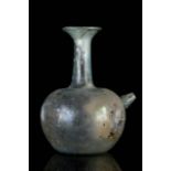 A ROMAN GREEN GLASS BABY FEEDER